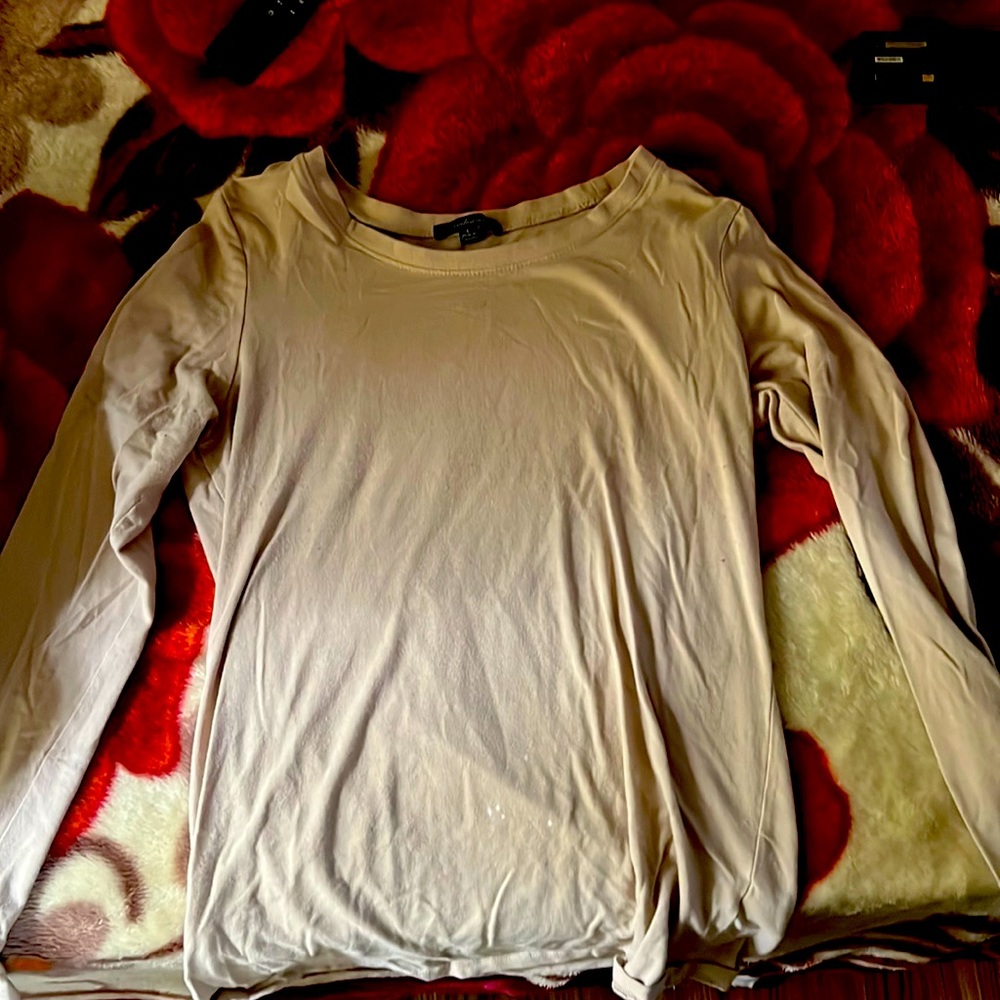 I’m selling a cream shirt and it’s a long sleeve it’s good fabric and quality.